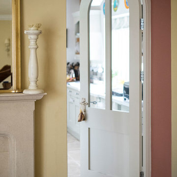 White Curved Doors leading to Modern Green Kitchen