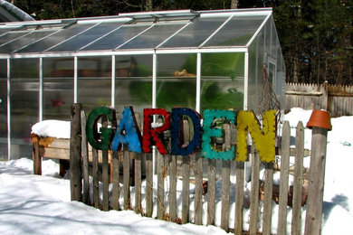 This is an example of an eclectic backyard garden for winter in Boston.