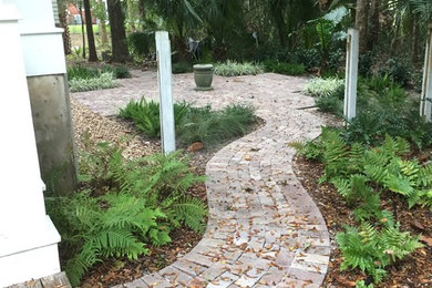 Inspiration for a small craftsman side yard concrete paver water fountain landscape in Miami.