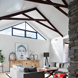 Design ideas for a contemporary family room in Melbourne with white walls, medium hardwood floors and brown floor.