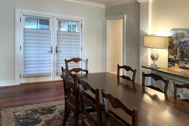 Example of a classic dark wood floor dining room design in Seattle with yellow walls