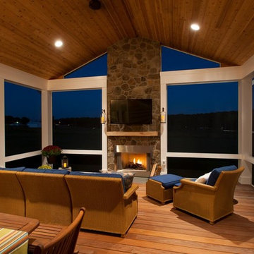 Design Builders screened porch with stone fireplace & Ipe deck in Sykesville MD