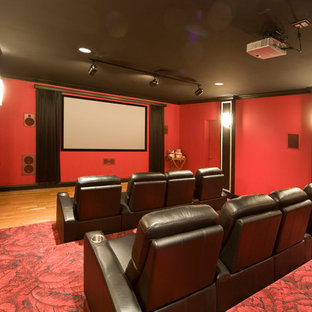 Inspiration for a modern carpeted home theater remodel in Burlington with red walls and a projector screen