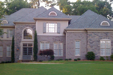 Large transitional three-story exterior home idea in Atlanta