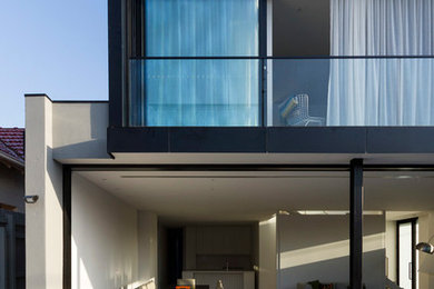 Photo of a mid-sized modern two-storey grey exterior in Melbourne.