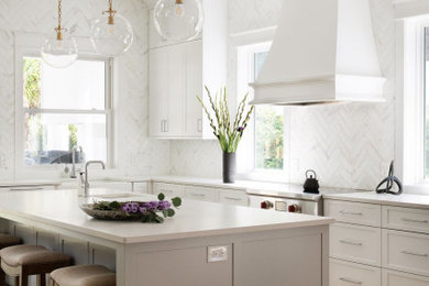 Transitional single-wall kitchen in Jacksonville with raised-panel cabinets, white cabinets, white splashback, marble splashback and with island.