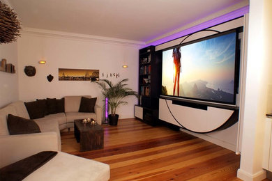 Foto de salón abierto clásico de tamaño medio sin chimenea y televisor con paredes blancas, suelo de madera en tonos medios y suelo marrón