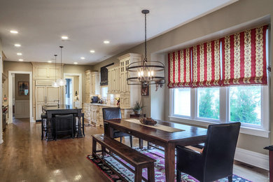 Example of a large farmhouse l-shaped dark wood floor enclosed kitchen design in Chicago with an undermount sink, raised-panel cabinets, beige cabinets, concrete countertops, beige backsplash, stone tile backsplash, stainless steel appliances and an island