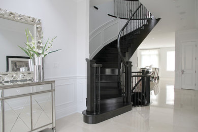 This is an example of a large contemporary foyer in Toronto with white walls, marble floors, a single front door and white floor.