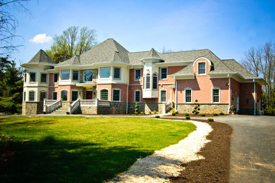 Inspiration for a large red two-story brick exterior home remodel in Baltimore