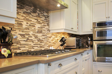 Mid-sized elegant u-shaped dark wood floor open concept kitchen photo in Toronto with an undermount sink, recessed-panel cabinets, white cabinets, quartz countertops, multicolored backsplash, glass tile backsplash, an island and paneled appliances