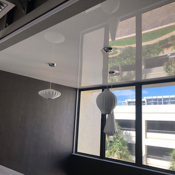 Hanging lights on a glossy stretch ceiling