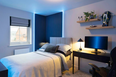 Medium sized modern master bedroom in Buckinghamshire with blue walls, carpet, no fireplace, grey floors, panelled walls and feature lighting.