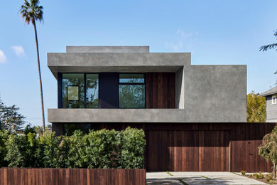 Example of a large minimalist gray split-level stucco exterior home design in Los Angeles