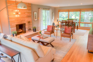 Inspiration for a mid-sized transitional formal and open concept light wood floor and beige floor living room remodel in St Louis with gray walls, a standard fireplace, a stone fireplace and no tv