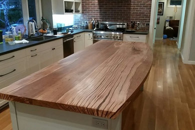 Inspiration for a large contemporary u-shaped light wood floor and beige floor enclosed kitchen remodel in San Francisco with an undermount sink, shaker cabinets, white cabinets, wood countertops and an island