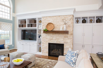Inspiration for a mid-sized transitional light wood floor family room remodel in DC Metro with blue walls, a standard fireplace, a stone fireplace and a media wall
