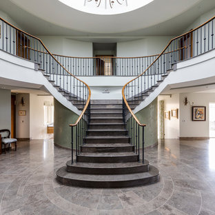 Traditional tiled curved wood railing staircase in Wiltshire with tiled risers.