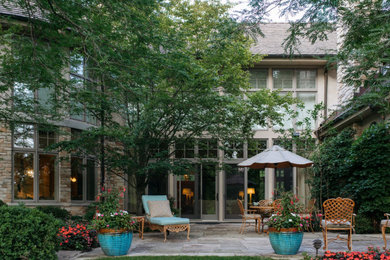 Mid-sized elegant backyard stone patio photo in Chicago