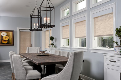 Example of a mid-sized transitional medium tone wood floor kitchen/dining room combo design in Tampa with blue walls