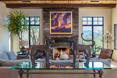 Large southwest open concept limestone floor and beige floor living room photo in Phoenix with beige walls, a standard fireplace, a stone fireplace and no tv