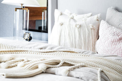 Inspiration for a mid-sized transitional master wallpaper bedroom remodel in Baltimore with gray walls, a standard fireplace and a wood fireplace surround