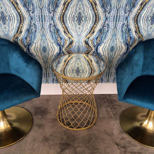 This is an example of a medium sized modern study in DC Metro with blue walls and carpet.