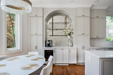 Eat-in kitchen - large transitional l-shaped dark wood floor and brown floor eat-in kitchen idea in DC Metro with shaker cabinets, black cabinets, quartzite countertops, white backsplash, quartz backsplash, stainless steel appliances, an island, white countertops and an undermount sink