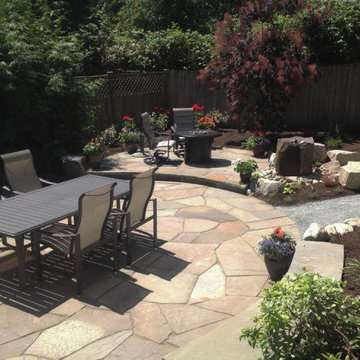 Hardscapes: stone patio with dining table, lounge area with fire pit