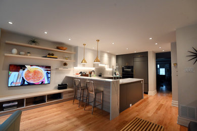 Mid-sized minimalist u-shaped light wood floor and brown floor open concept kitchen photo in Toronto with a drop-in sink, flat-panel cabinets, white cabinets, quartzite countertops, white backsplash, stone slab backsplash, paneled appliances, a peninsula and white countertops