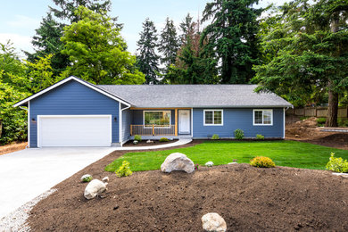 Mid-sized transitional one-storey blue house exterior in Seattle with vinyl siding, a gable roof and a shingle roof.