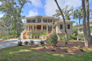 Inspiration for a large timeless beige three-story stucco exterior home remodel in Atlanta with a hip roof