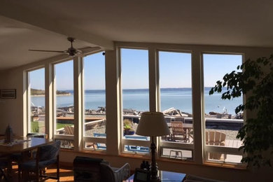 Example of a large classic formal and enclosed light wood floor and brown floor living room design in Seattle with beige walls, no fireplace and no tv