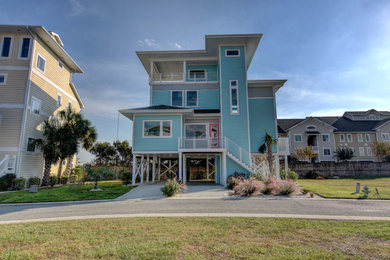 Example of a beach style home design design in Other