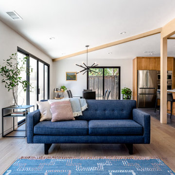 Open Floor Plan Streng Home with Walnut Wrapped Exposed Beams