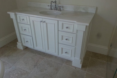 Inspiration for a mid-sized beach style master bathroom in Miami with flat-panel cabinets, white cabinets, marble benchtops, beige tile, stone tile, beige walls and travertine floors.