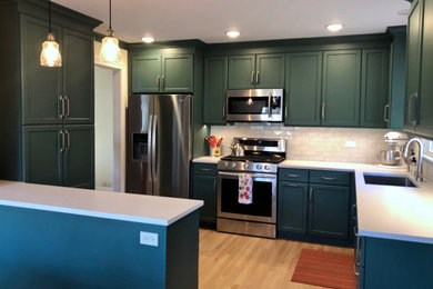 Small transitional u-shaped light wood floor and brown floor eat-in kitchen photo in Chicago with a single-bowl sink, shaker cabinets, green cabinets, quartz countertops, gray backsplash, ceramic backsplash, stainless steel appliances, a peninsula and white countertops