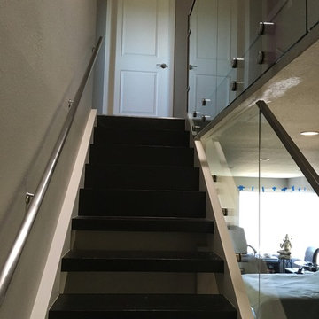Glass panels with stainless steel cap rails, railing and supoort post.