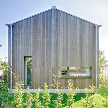 Neubau eines Ferienhauses mit Holzfassade und hellem Lichtband am Meer