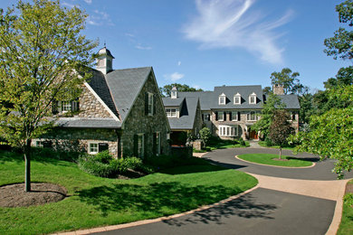 Inspiration for a large timeless three-story stone exterior home remodel in Philadelphia
