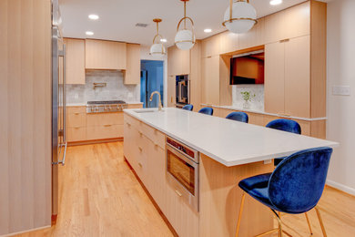 Eat-in kitchen - contemporary u-shaped medium tone wood floor eat-in kitchen idea in Baltimore with an undermount sink, flat-panel cabinets, light wood cabinets, quartz countertops, beige backsplash, porcelain backsplash, stainless steel appliances, an island and white countertops