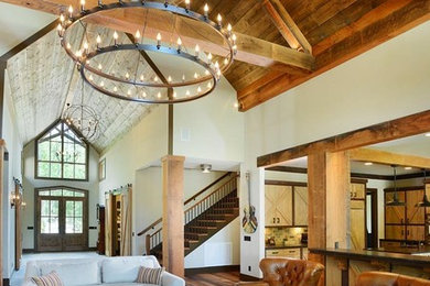 Mid-sized mountain style open concept medium tone wood floor living room photo in Nashville with white walls