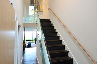 Inspiration for a modern wooden straight staircase remodel in San Francisco with wooden risers