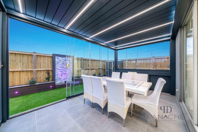 Mid-sized modern backyard patio in Melbourne with tile and a pergola.