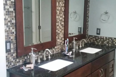 Bathroom - mid-sized contemporary master beige tile, black tile, brown tile, white tile and glass tile porcelain tile and beige floor bathroom idea with shaker cabinets, dark wood cabinets, gray walls, an undermount sink and granite countertops