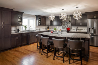 Open concept kitchen - large contemporary l-shaped light wood floor open concept kitchen idea in Boston with a single-bowl sink, flat-panel cabinets, dark wood cabinets, granite countertops, white backsplash, glass tile backsplash, stainless steel appliances and an island