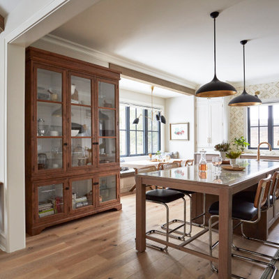 Inspiration for an eclectic light wood floor and brown floor eat-in kitchen remodel in Chicago with recessed-panel cabinets, white cabinets, quartzite countertops, white backsplash, stainless steel appliances, an island and yellow countertops