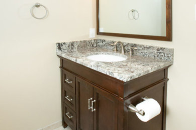 Bathroom - mid-sized traditional 3/4 ceramic tile and beige floor bathroom idea in DC Metro with shaker cabinets, dark wood cabinets, beige walls, an undermount sink and granite countertops