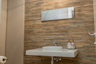 Inspiration for a small modern 3/4 mosaic tile light wood floor bathroom remodel in Montreal with a one-piece toilet, gray walls and a wall-mount sink