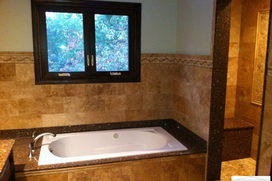 Bathroom - large modern brown tile and stone tile travertine floor bathroom idea in Chicago with an undermount sink, flat-panel cabinets, dark wood cabinets, quartzite countertops and a two-piece toilet